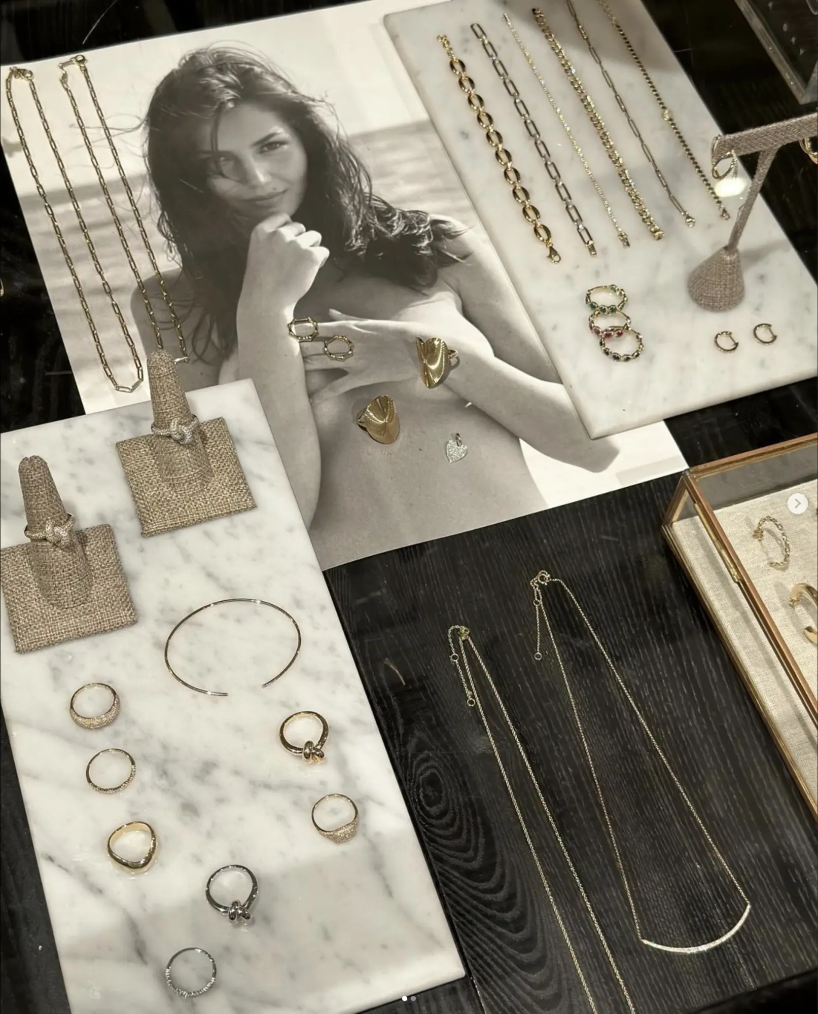 Gold jewellery on marble and dark wood at Alchemy Works