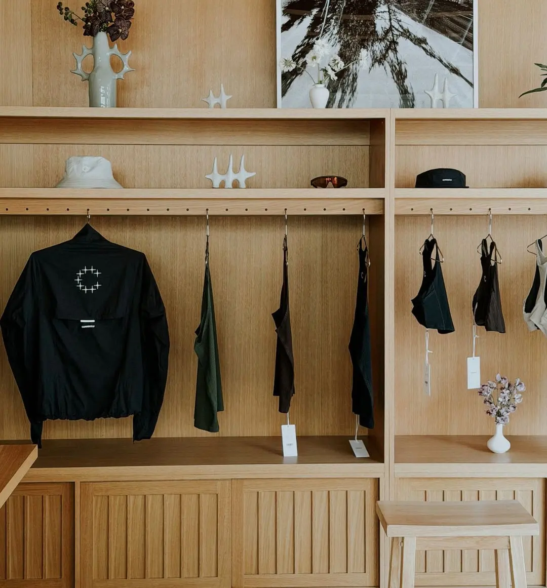 Running apparel on wooden shelves in the Currently Running store at Signal