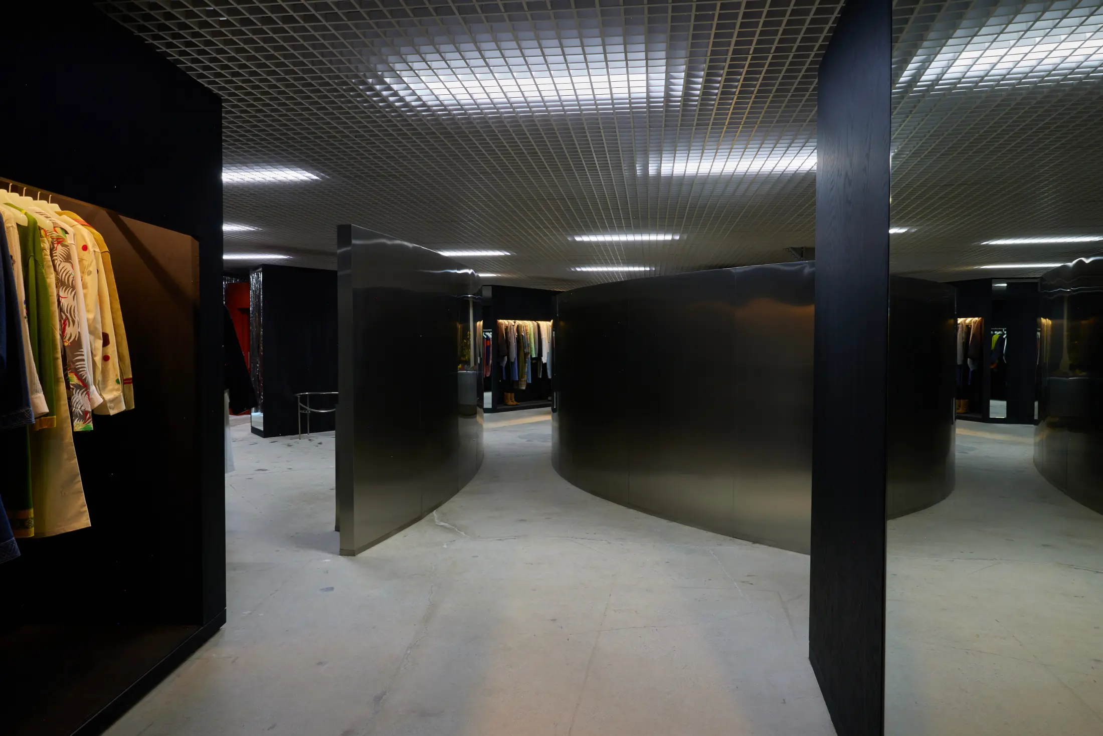 Inside Departamento at Signal, with black walls and clothing rails