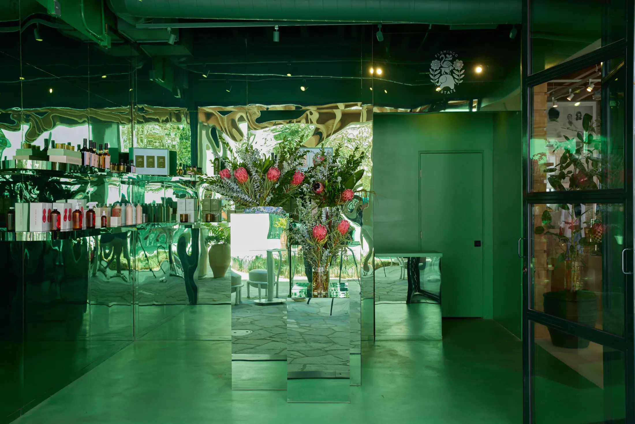 Inside the Flamingo Estate store at Signal, flowers in green light