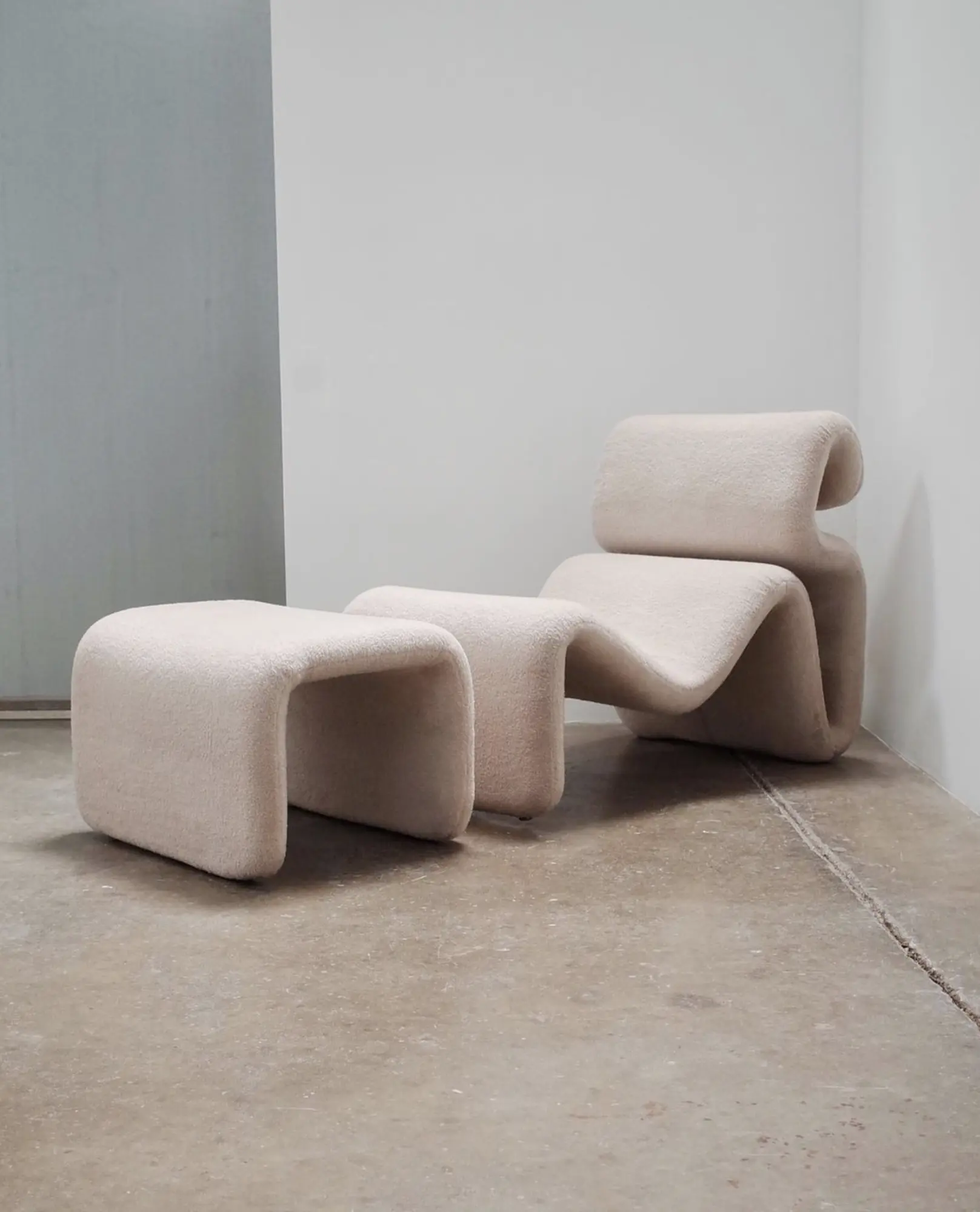 A pale sculptural lounge chair and ottoman at Formas