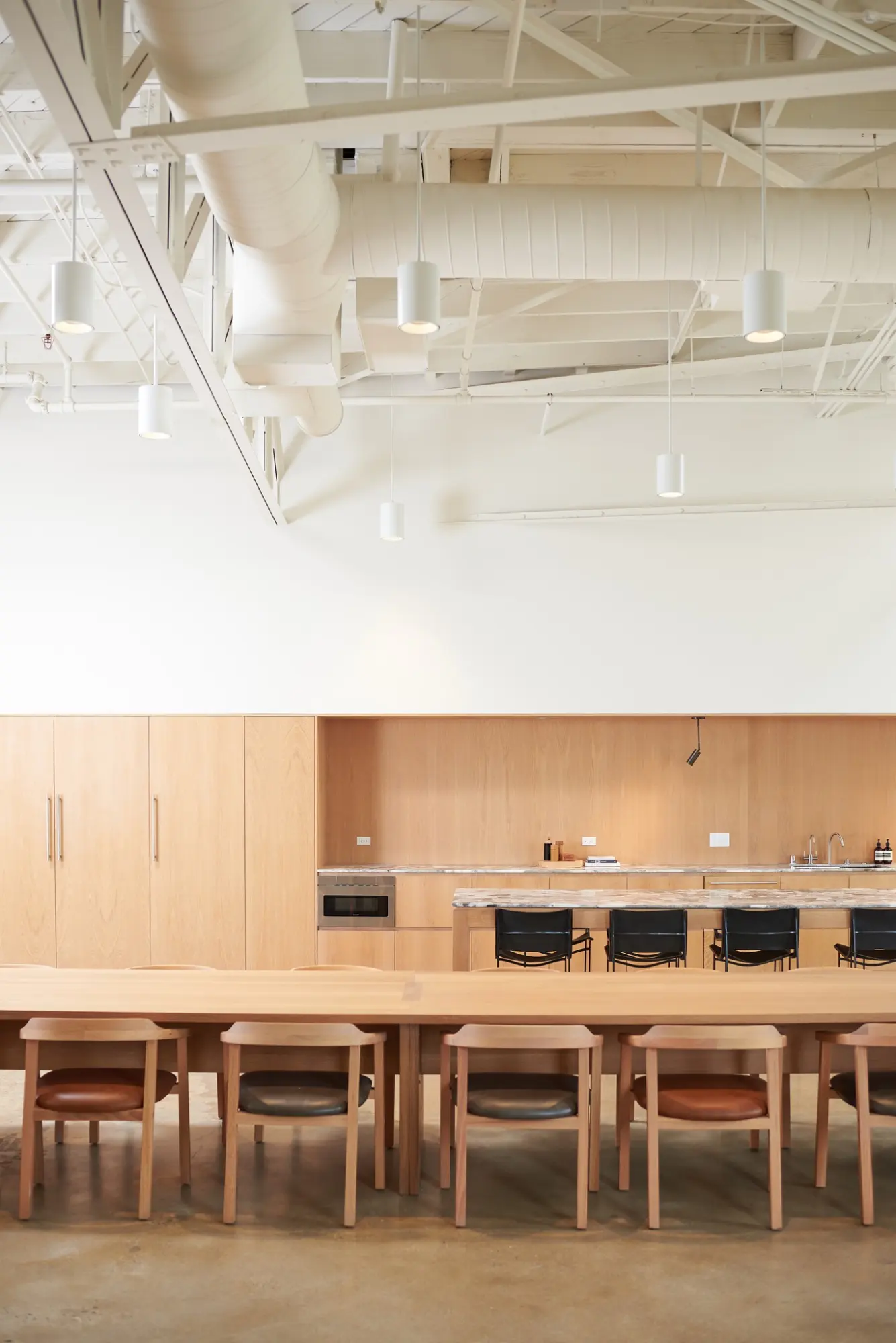 The kitchen and a long table in the Greycroft office at Signal