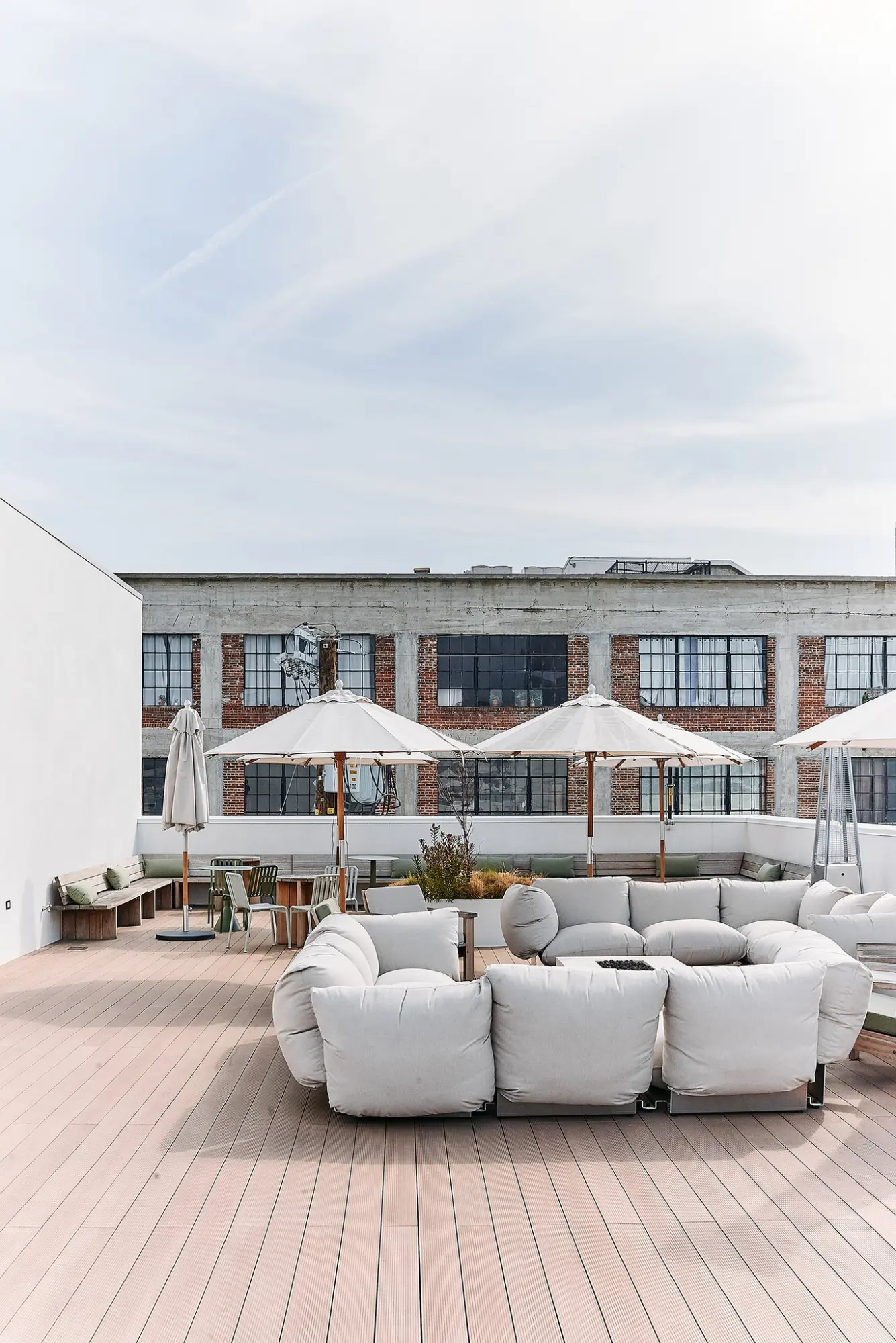 Sofas and umbrellas on the Greycroft roof terrace at Signal