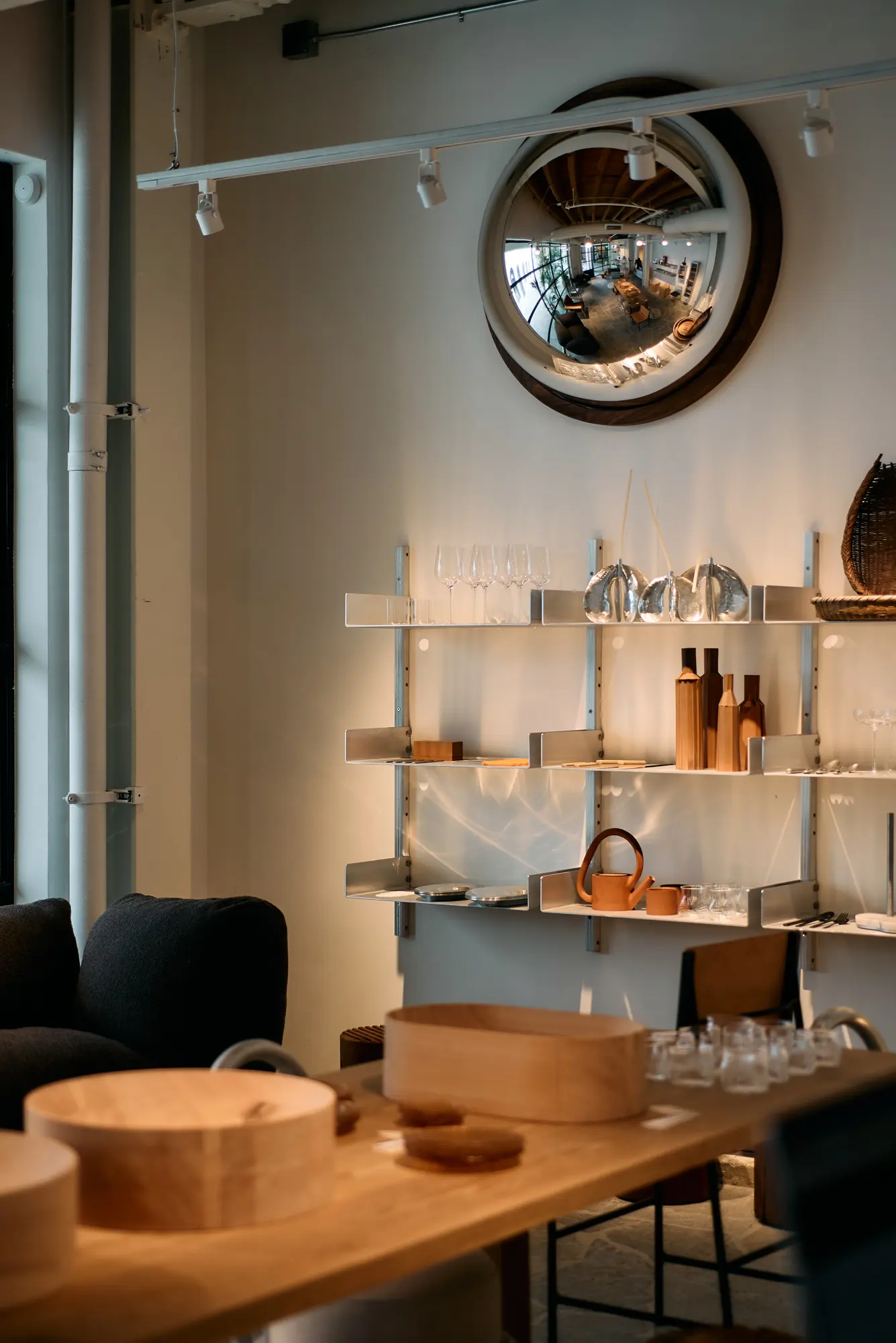 A round mirror above shelves in the Klein home store at Signal