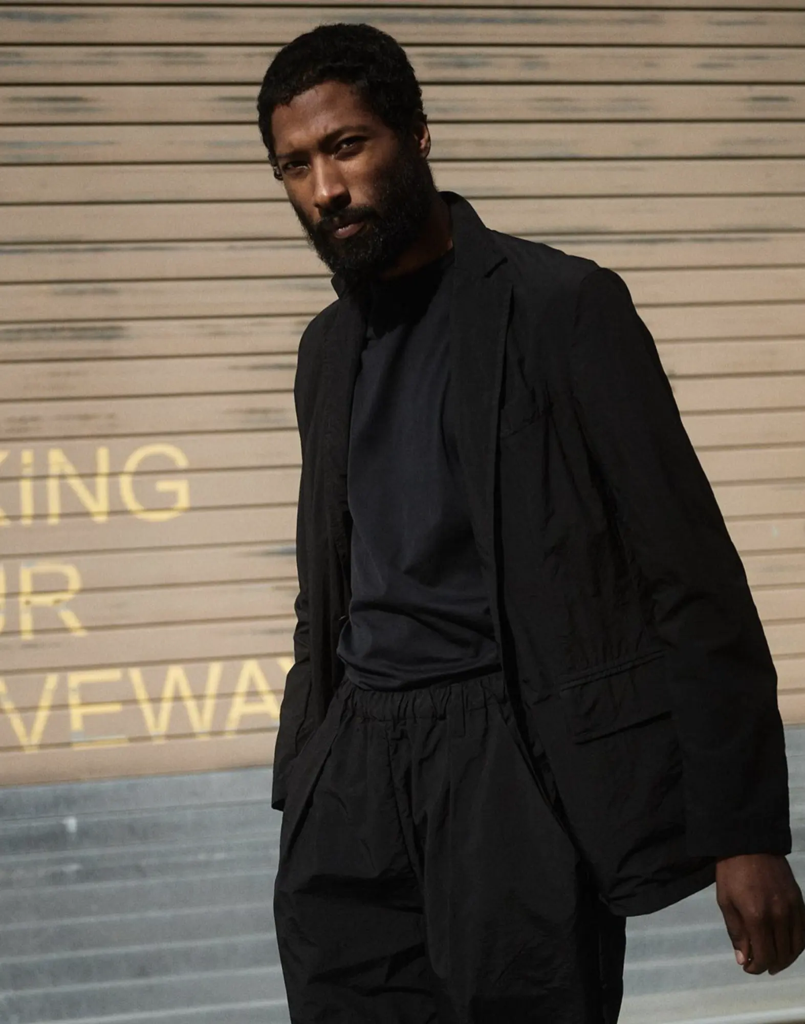 A man in a black suit, M5
