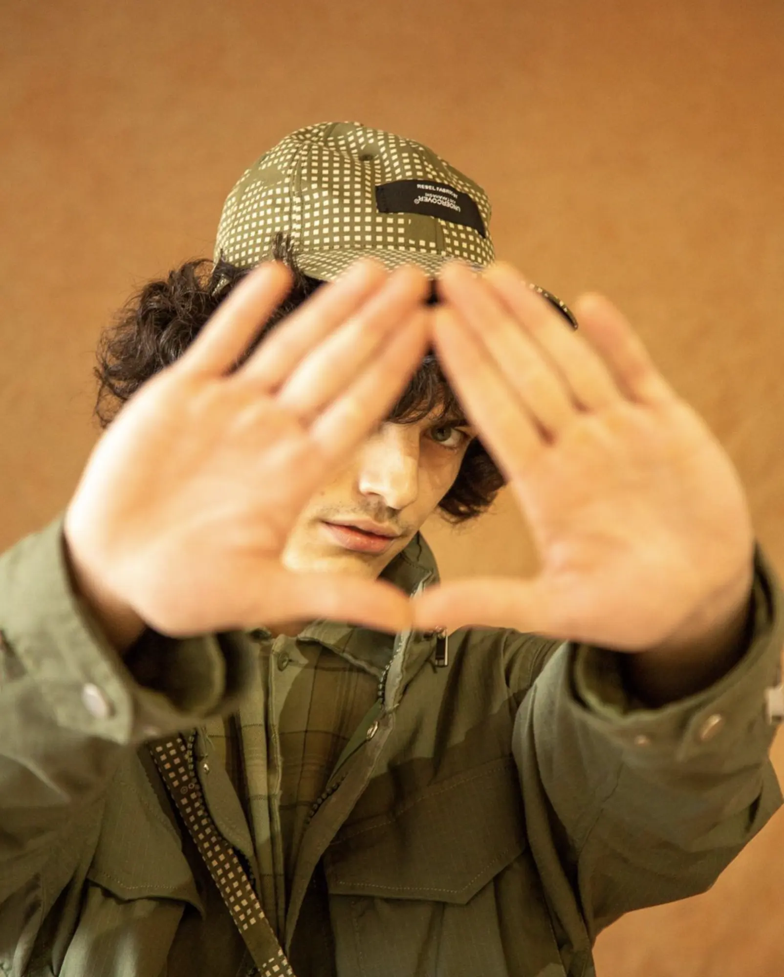 A camouflage cap and olive jacket, M5