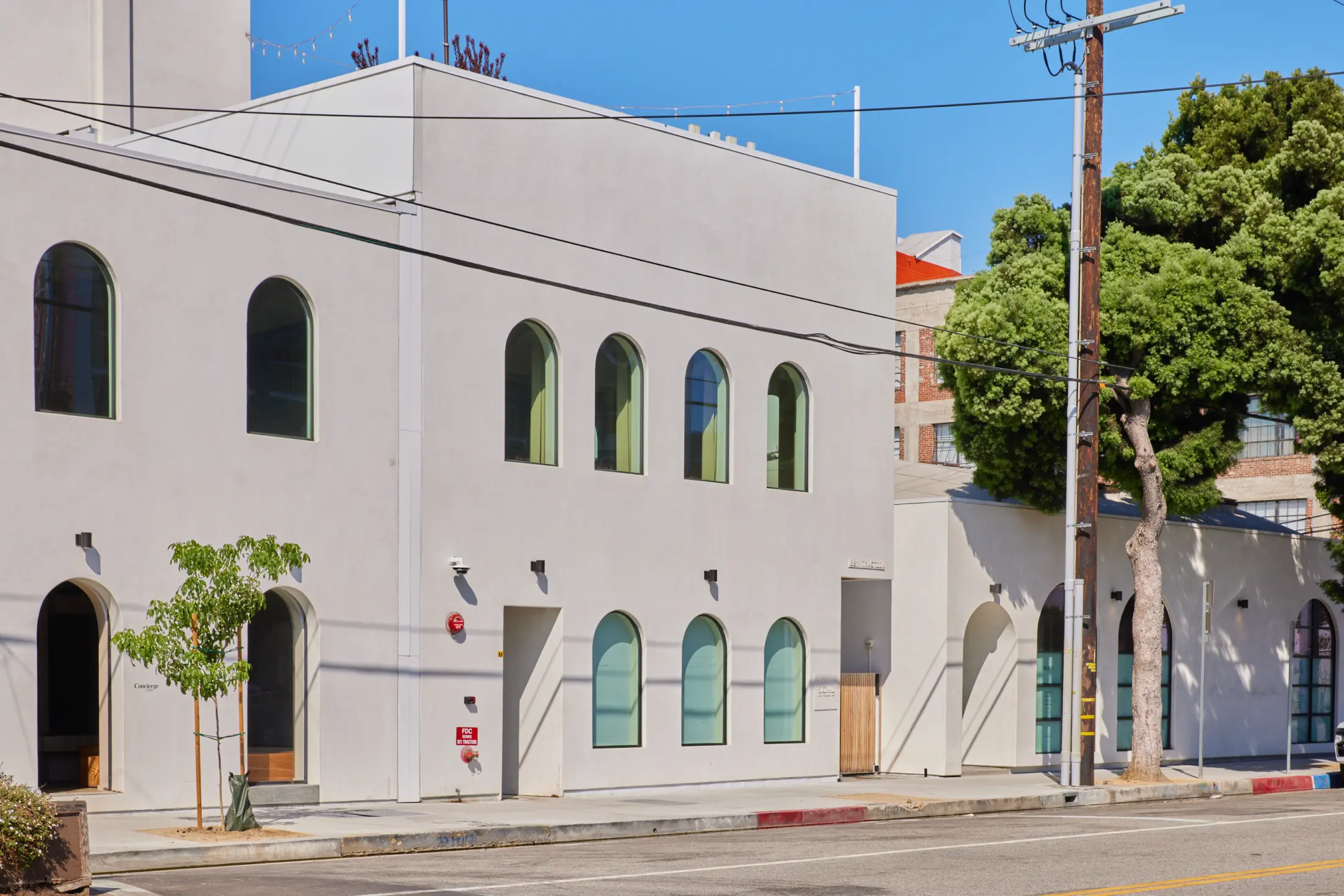 The white facade of Signal with arched windows on Traction Ave in the Arts District, Los Angeles