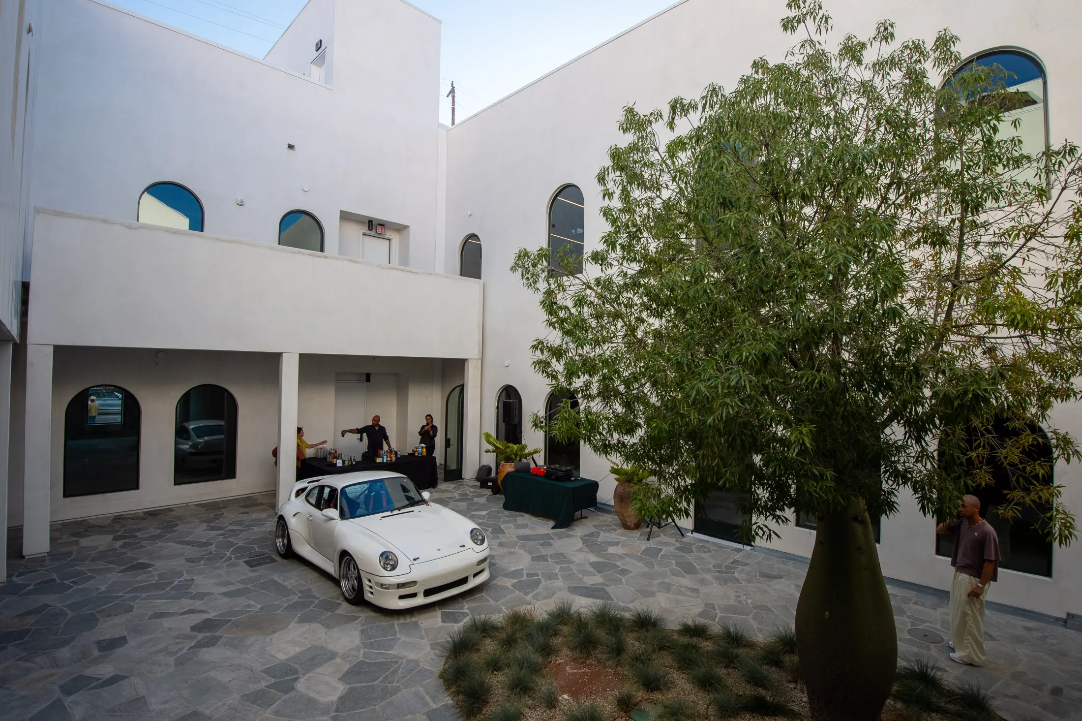 A white Porsche beside the bottle tree in the courtyard at Signal