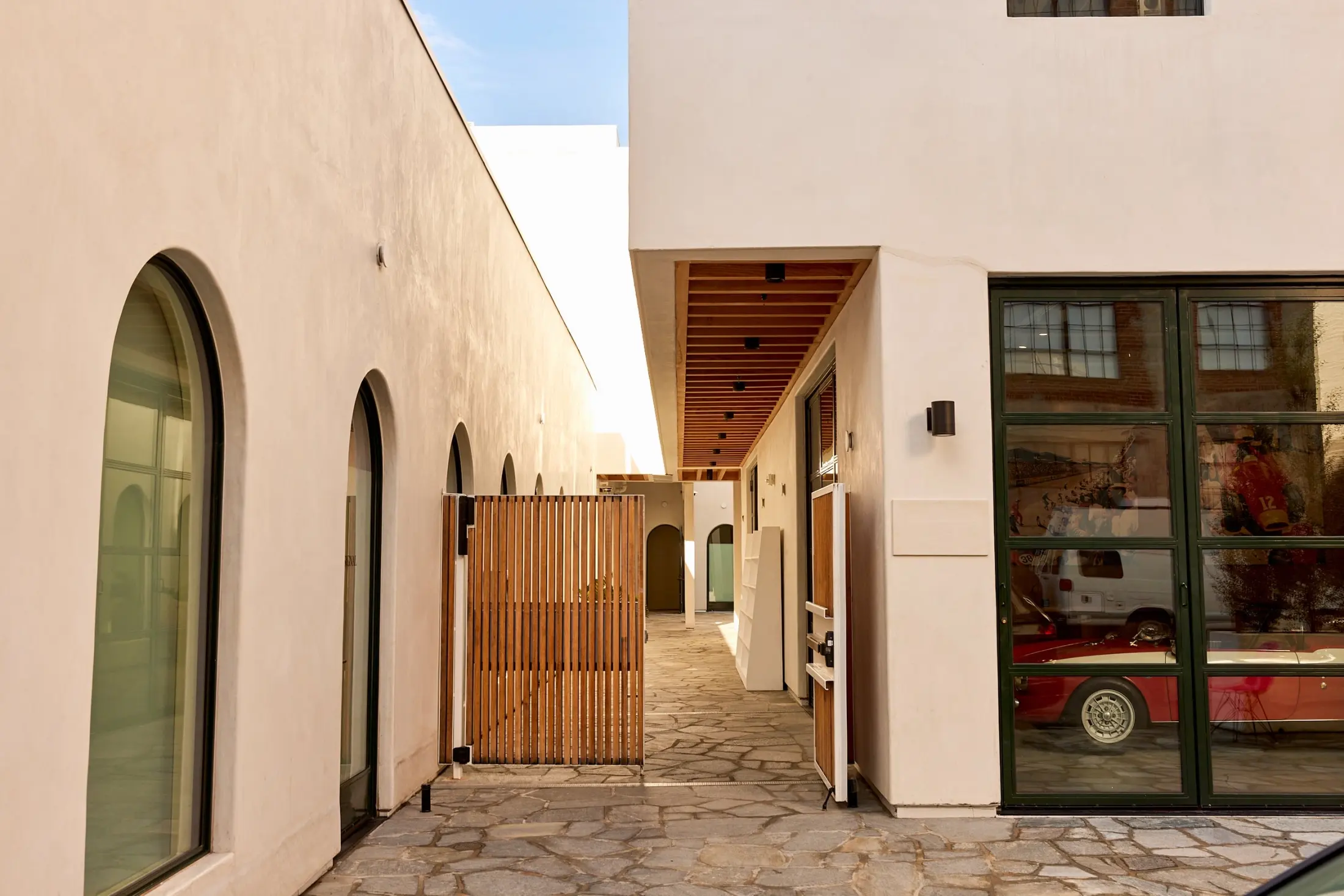 A stone passage off the courtyard at Signal, with arched windows and shopfronts